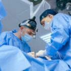 Male,Surgeons,Perform,Surgery,In,Operating,Room,,Plastic,Surgeon,In